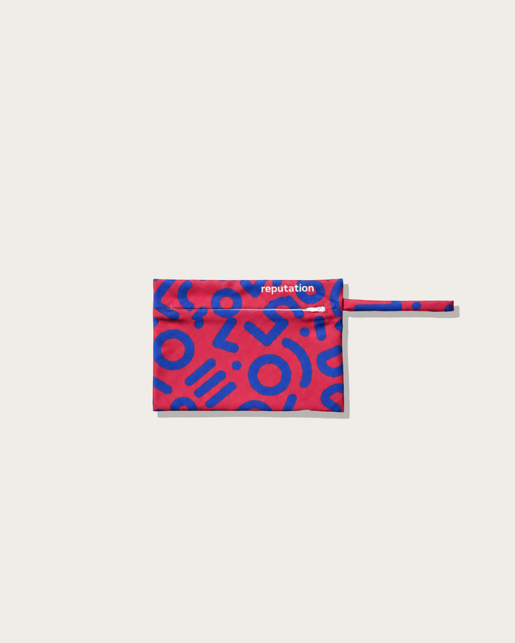 Reputation Glyph print swimwear packaging pouch, flat lay